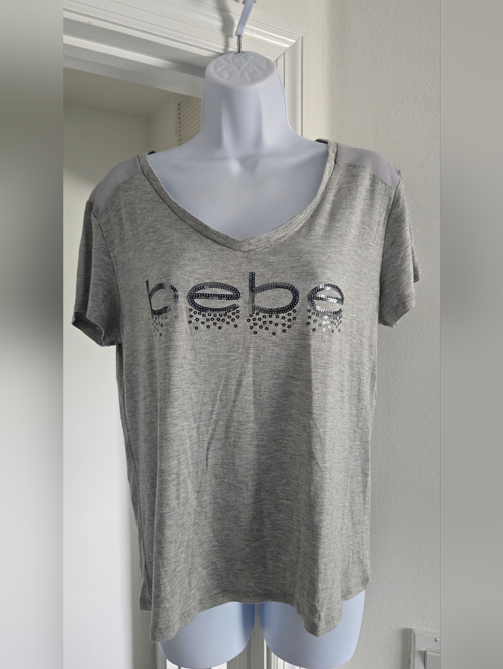 Bebe Sport loose fitting gray Short Sleeve V-Neck Logo Tee with sheer shoulders